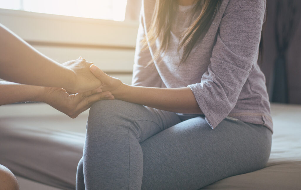 Man giving hand to depressed woman,Psychiatrist holding hands patient,Mental health care concept