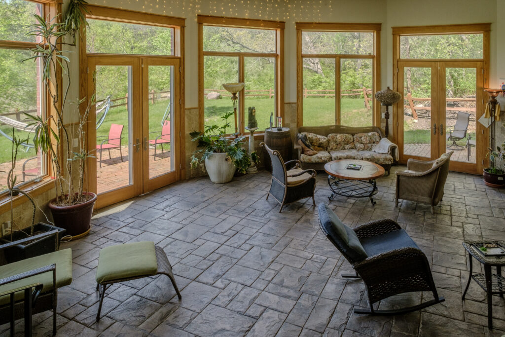 Bright, airy atrium interior at Top of the World Ranch addiction rehab facility, filled with natural light and serene views to promote peace and emotional wellness during recovery.