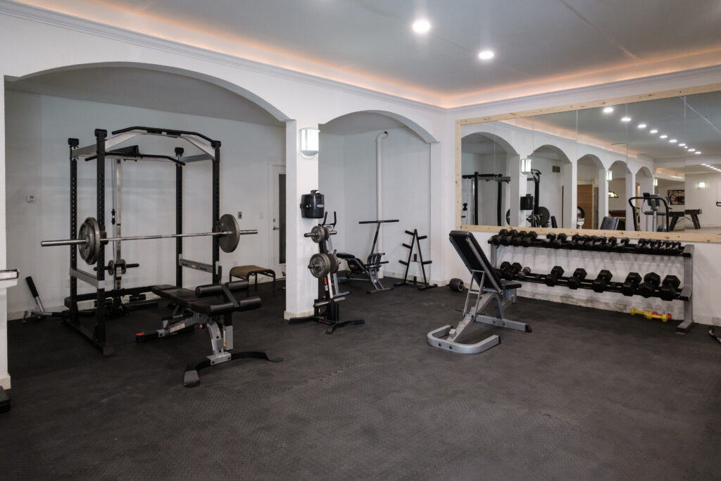 Modern gymnasium interior with fitness equipment at Top of the World Ranch, a luxury residential treatment center encouraging exercise for mental and emotional wellness.